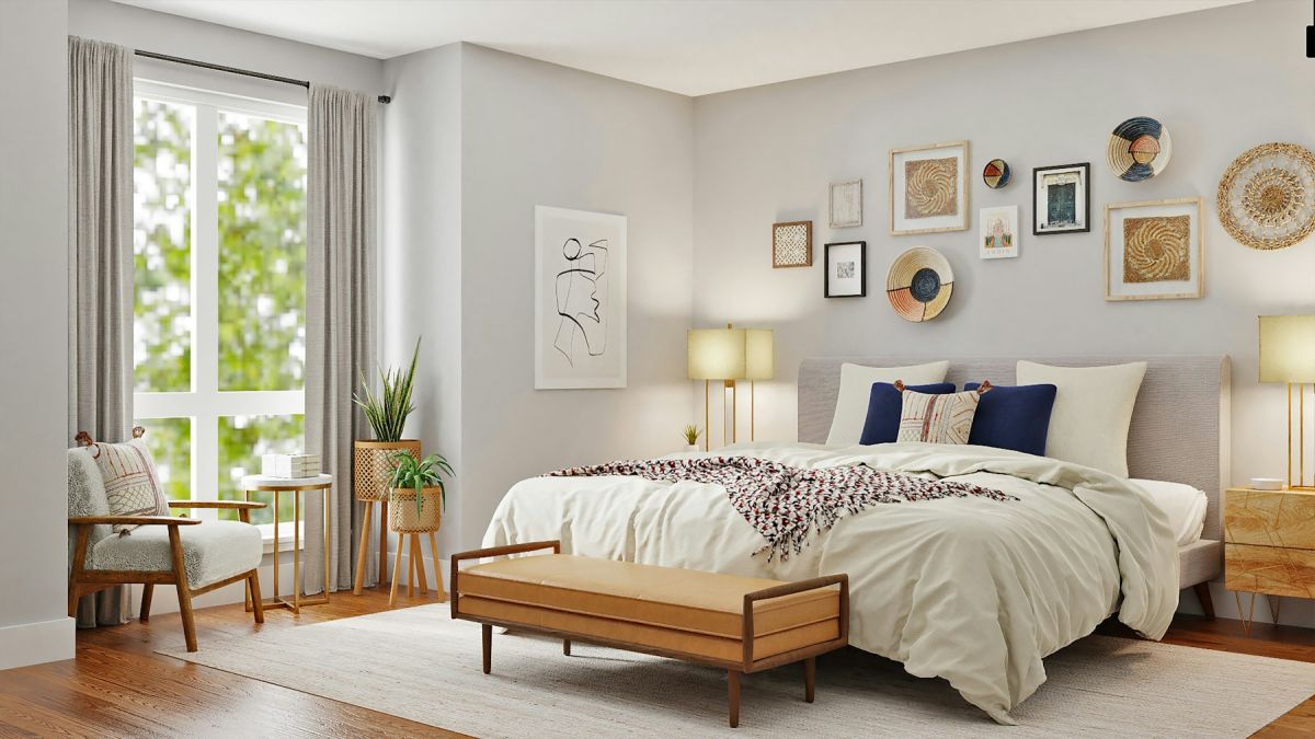 Bright modern bedroom with a neatly made king bed, wall art, bench and large window